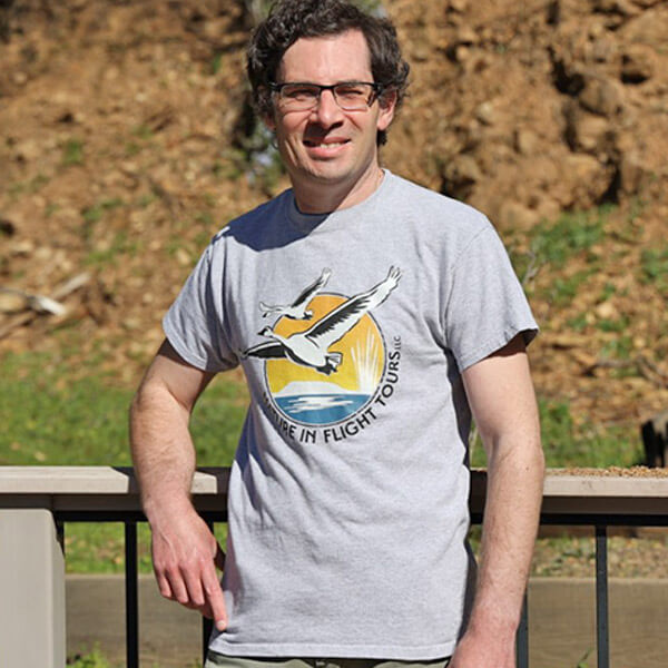 Spencer wearing T-shirt with Nature in Flight logo