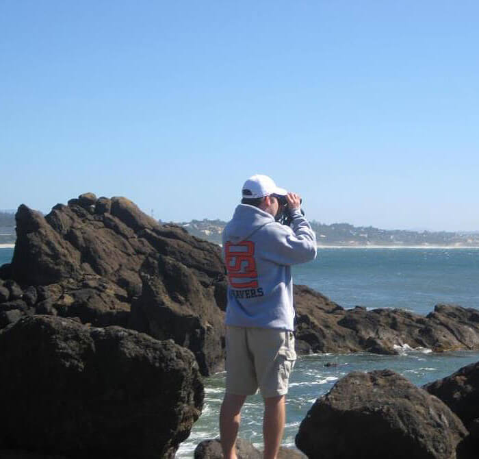 Looking at birds through binoculars on the Oregon coast